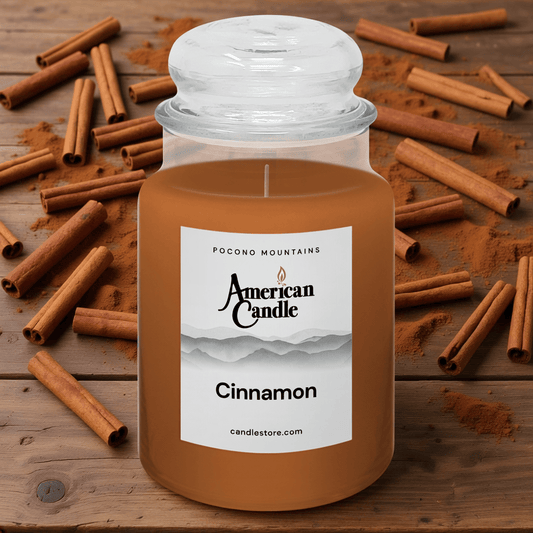 American Candle Cinnamon-scented jar candle with cinnamon sticks on a wooden table