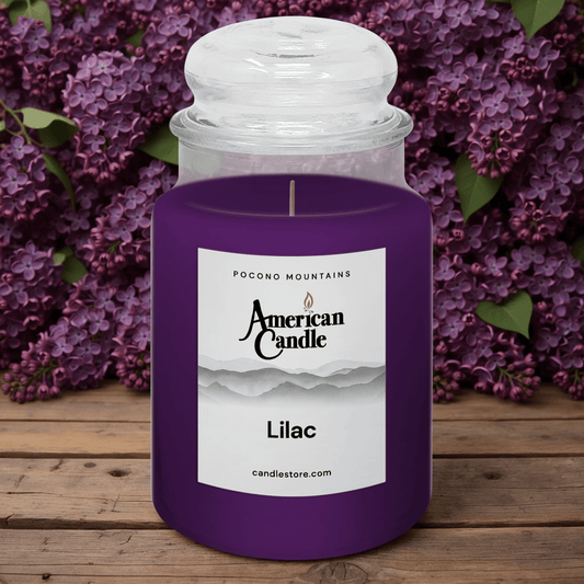 American Candle Lilac Scented Jar Candle on Wooden Table with Lilacs in background