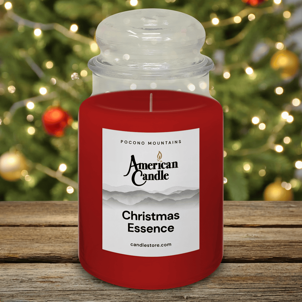 American Candle Christmas Essence Scented Jar Candle with a Christmas tree in the background on wooden table