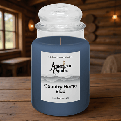American Candle County Home Blue Scented Jar Candle on Wooden Table inside a Log Cabin