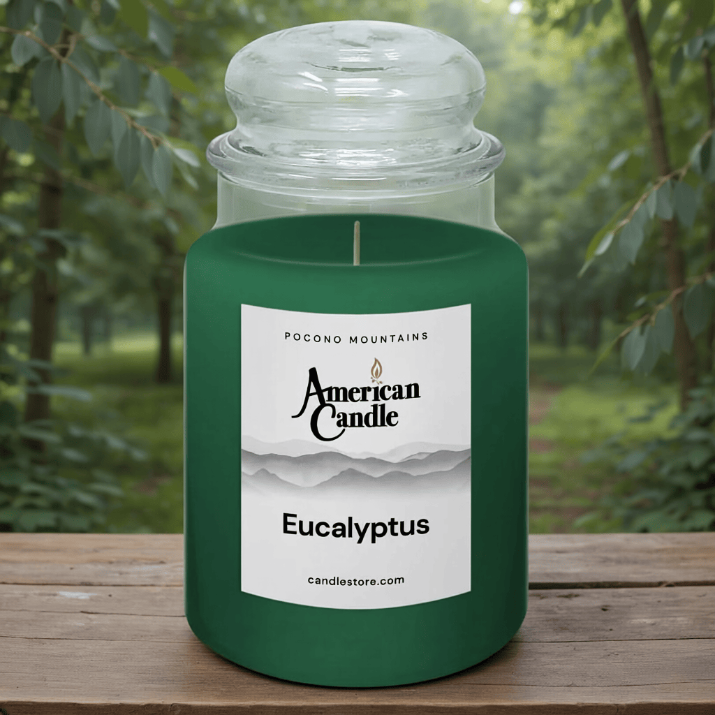 American Candle Eucalyptus Scented Jar Candle on a Wooden Table in front of Eucalyptus Trees