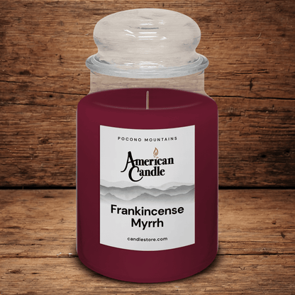 American Candle Frankincense Myrrh scented jar candle on a wooden table