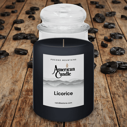 American Candle Licorice Scented Jar Candle on a wooden tables with licorice candies.