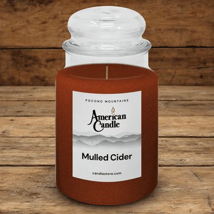 American Candle Mulled Cider scented jar candle on a wooden table