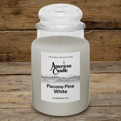 American Candle Pocono Pine White Scented Jar Candle on a Wooden Table