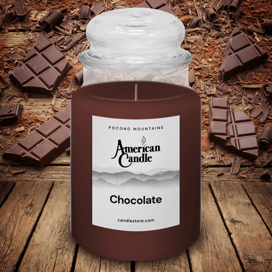 American Candle Chocolate-scented jar candle on a wooden stable with chocolate pieces