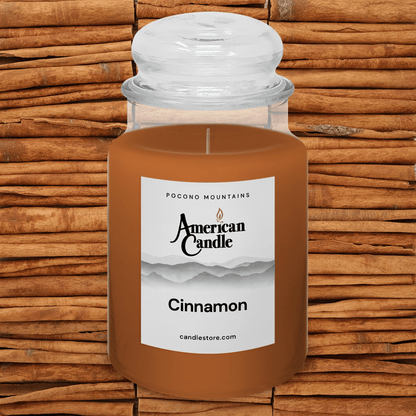 American Candle Cinnamon-scented jar candle with Cinnamon sticks background