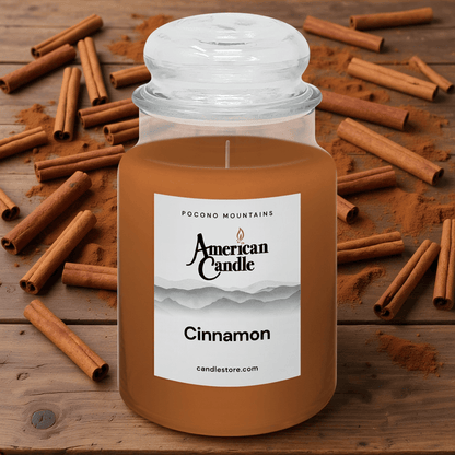 American Candle Cinnamon-scented jar candle with cinnamon sticks on a wooden table