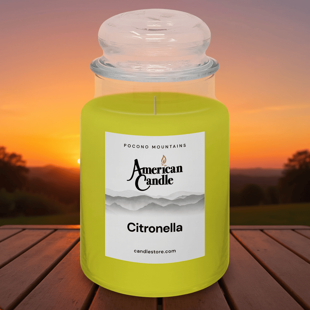 American Candle Citronella scented jar candle with a sunset background on wooded table