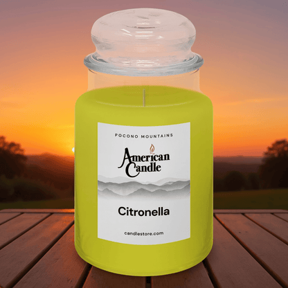 American Candle Citronella scented jar candle with a sunset background on wooded table