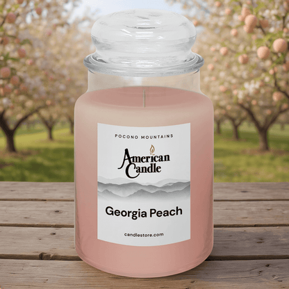 American Candle Georgia Peach scented jar candle with an peach orchard in the background